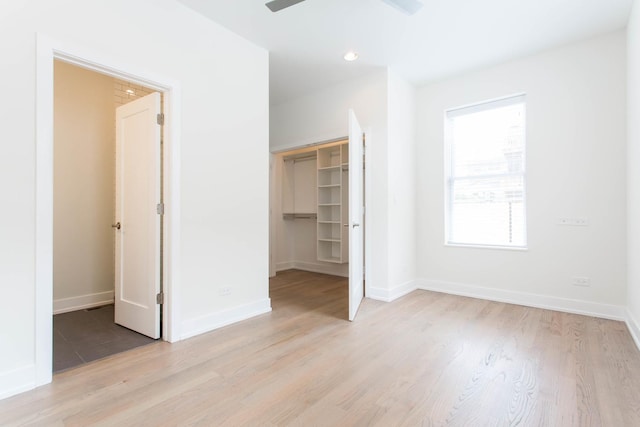 1407 N Bosworth Ave, Chicago, IL 60642 - unfurnished bedroom with a spacious closet, light wood-style floors, baseboards, a closet, and recessed lighting