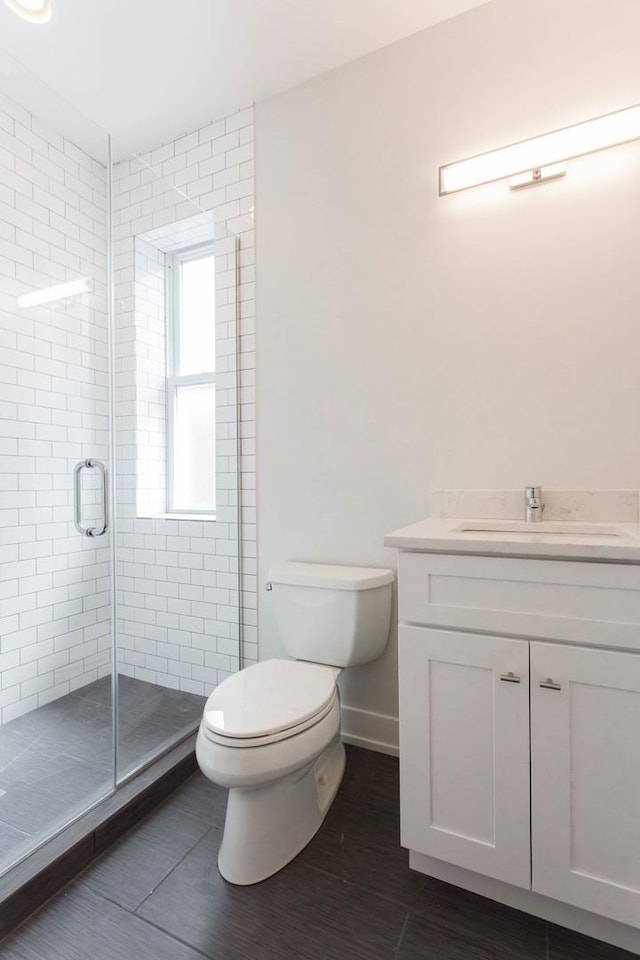 1407 N Bosworth Ave, Chicago, IL 60642 - bathroom with toilet, vanity, a stall shower, and baseboards