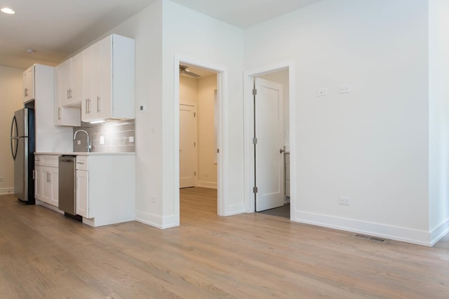 1407 N Bosworth Ave, Chicago, IL 60642 - kitchen with stainless steel appliances, light countertops, light wood finished floors, white cabinetry, and recessed lighting