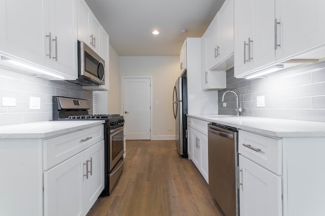 1407 N Bosworth Ave, Chicago, IL 60642 - kitchen with stainless steel appliances, backsplash, wood finished floors, a sink, and recessed lighting
