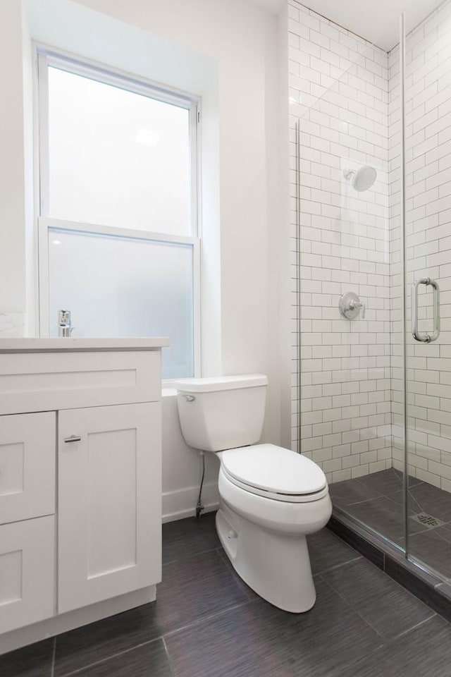 1407 N Bosworth Ave, Chicago, IL 60642 - bathroom with a stall shower, toilet, vanity, baseboards, and wood finished floors