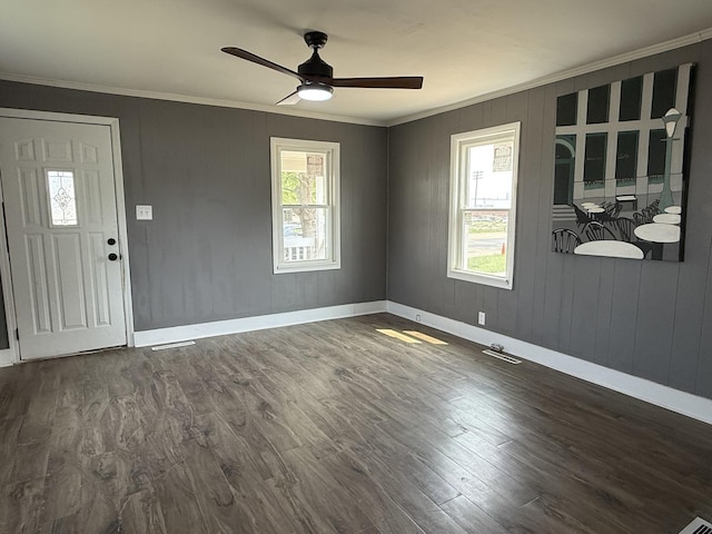 302 E Carroll St, Lanark, IL 61046 - foyer entrance featuring crown molding, ceiling fan, healthy amount of natural light, dark wood finished floors, and baseboards