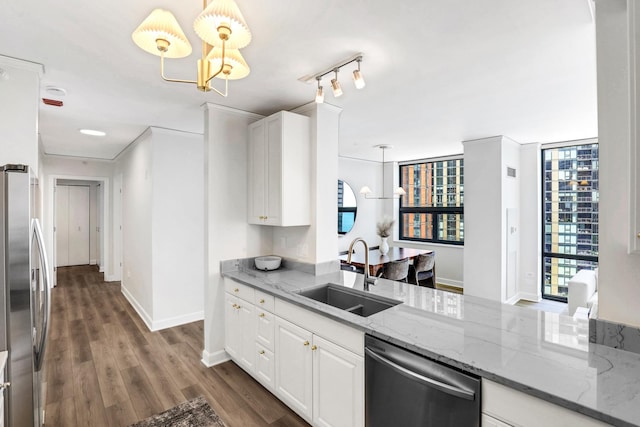 201 N Westshore Dr Unit 2102, Chicago, IL 60601 - kitchen featuring appliances with stainless steel finishes, a sink, a chandelier, white cabinetry, and light stone counters
