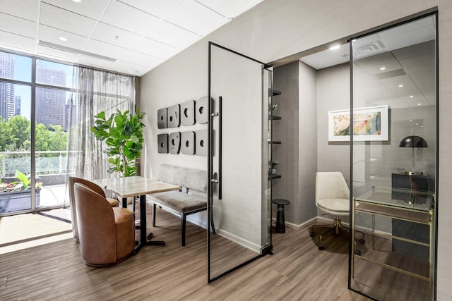 201 N Westshore Dr Unit 2102, Chicago, IL 60601 - home office with a wall of windows, wood finished floors, baseboards, and a view of city