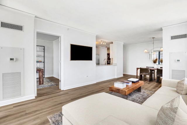 201 N Westshore Dr Unit 2102, Chicago, IL 60601 - living room featuring wood finished floors, a chandelier, and baseboards