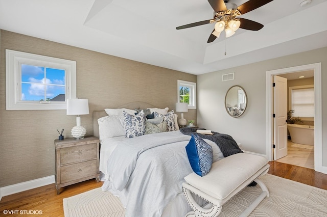234 E Saint Charles Rd, Elmhurst, IL 60126 - bedroom featuring a raised ceiling, wood finished floors, a ceiling fan, and connected bathroom