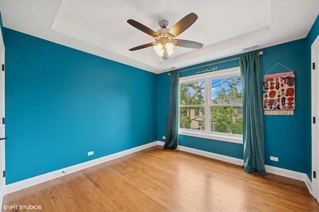234 E Saint Charles Rd, Elmhurst, IL 60126 - unfurnished room featuring a tray ceiling, a ceiling fan, and wood finished floors