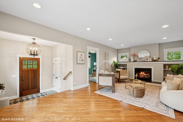234 E Saint Charles Rd, Elmhurst, IL 60126 - living area featuring wood finished floors, recessed lighting, a warm lit fireplace, and a chandelier