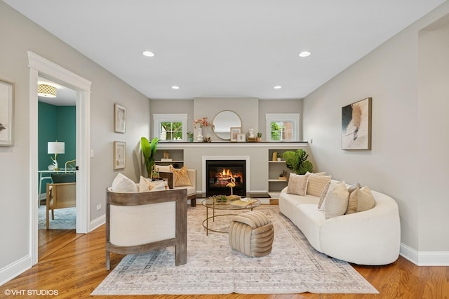 234 E Saint Charles Rd, Elmhurst, IL 60126 - living room with wood finished floors, a glass covered fireplace, and recessed lighting