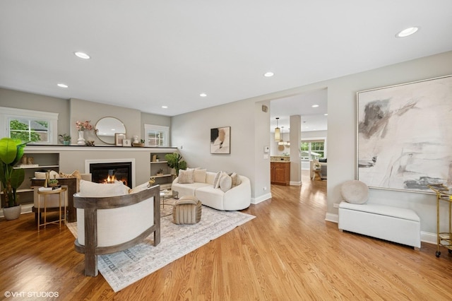 234 E Saint Charles Rd, Elmhurst, IL 60126 - living area with light wood finished floors, a glass covered fireplace, and recessed lighting