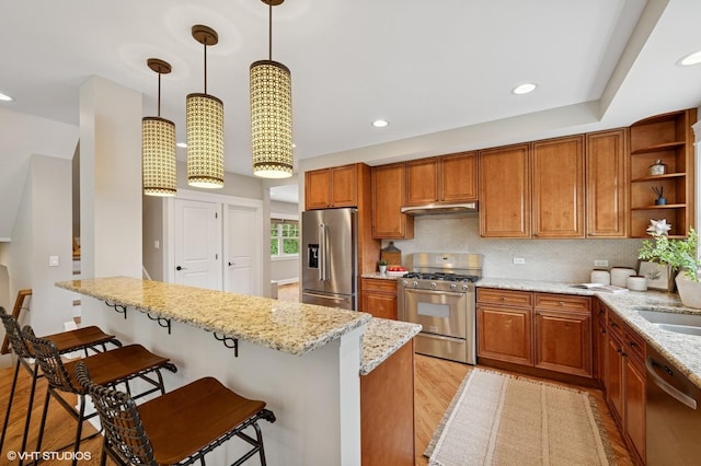 234 E Saint Charles Rd, Elmhurst, IL 60126 - kitchen with appliances with stainless steel finishes, a breakfast bar, light wood-style flooring, open shelves, and light stone countertops