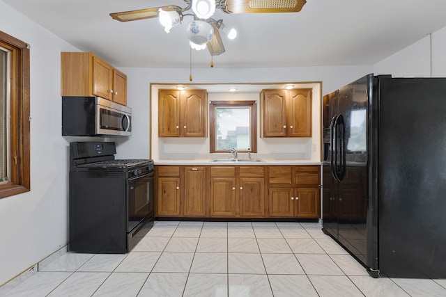 510 S Sycamore St, Genoa, IL 60135 - kitchen with black appliances, ceiling fan, a sink, brown cabinetry, and light countertops