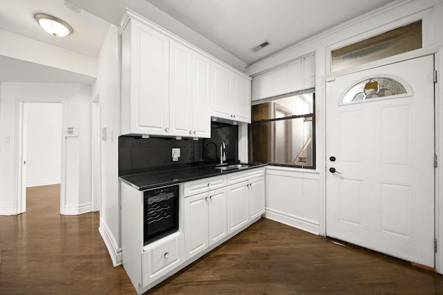 4054 W Palmer St Unit 2, Chicago, IL 60639 - kitchen with white cabinets, tasteful backsplash, dark countertops, and dark wood finished floors
