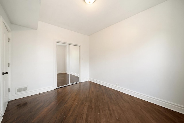 4054 W Palmer St Unit 2, Chicago, IL 60639 - unfurnished bedroom with dark wood-type flooring, baseboards, and a closet