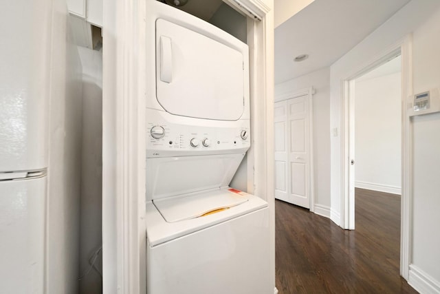 4054 W Palmer St Unit 2, Chicago, IL 60639 - laundry area with stacked washer and clothes dryer, dark wood-type flooring, water heater, and baseboards