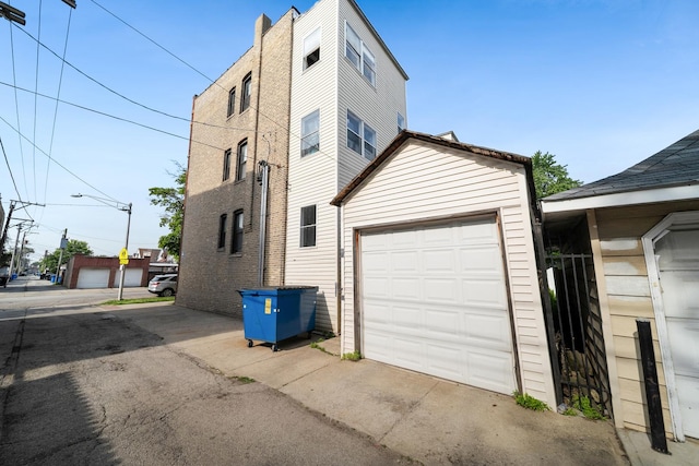 4054 W Palmer St Unit 2, Chicago, IL 60639 - view of property exterior with a garage and concrete driveway