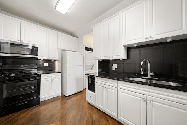 4054 W Palmer St Unit 2, Chicago, IL 60639 - kitchen featuring stainless steel microwave, freestanding refrigerator, black range with gas stovetop, stacked washer / drying machine, and a sink