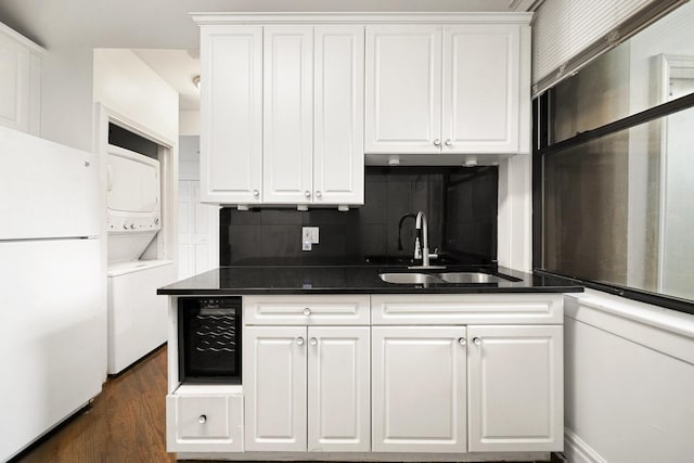 4054 W Palmer St Unit 2, Chicago, IL 60639 - kitchen with stacked washer and clothes dryer, freestanding refrigerator, a sink, beverage cooler, and white cabinets