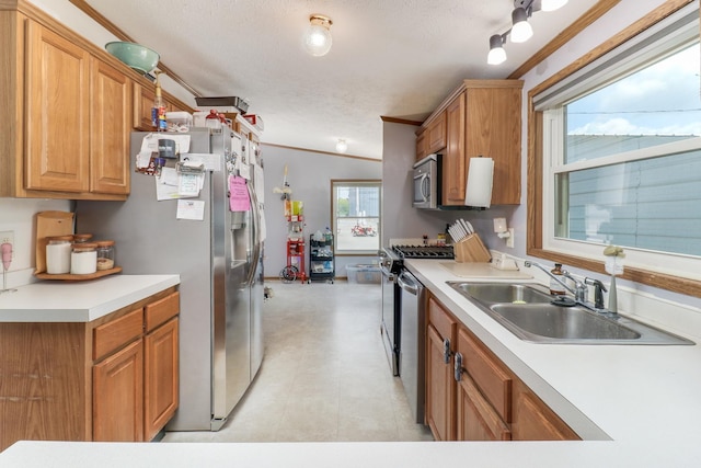 103 S Benson St, Lexington, IL 61753 - kitchen with stainless steel appliances, crown molding, light countertops, a textured ceiling, and brown cabinets