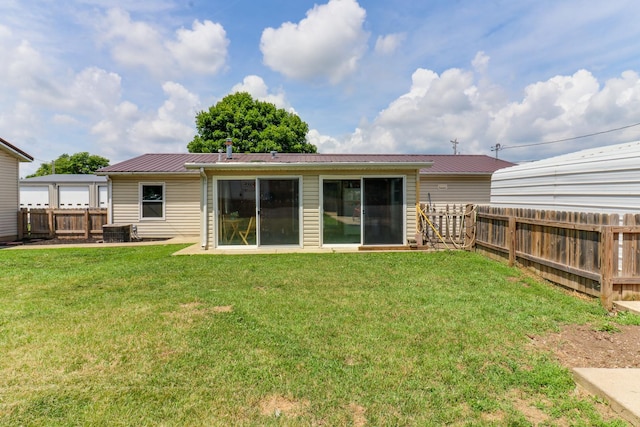103 S Benson St, Lexington, IL 61753 - back of house featuring a metal roof and a fenced backyard