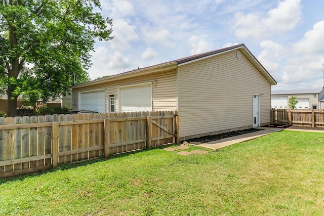 103 S Benson St, Lexington, IL 61753 - view of side of home with a garage and a fenced backyard