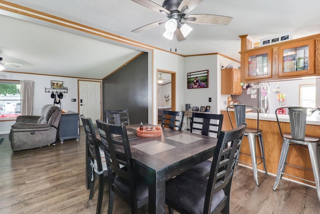 103 S Benson St, Lexington, IL 61753 - dining space featuring a ceiling fan, light wood-style floors, plenty of natural light, ornamental molding, and vaulted ceiling