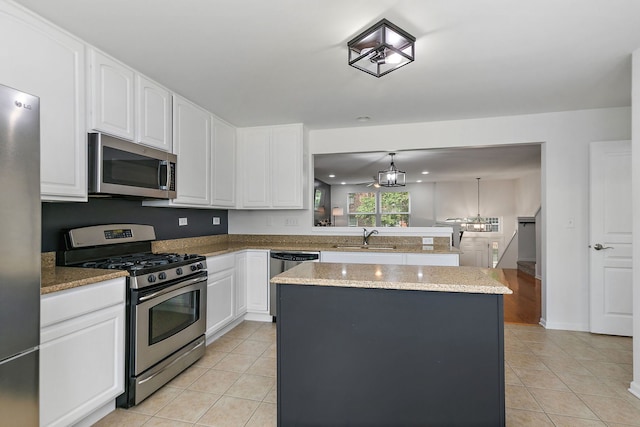 131 Bristol Ln Unit 2, Wood Dale, IL 60191 - kitchen featuring appliances with stainless steel finishes, a sink, light tile patterned floors, and a kitchen island