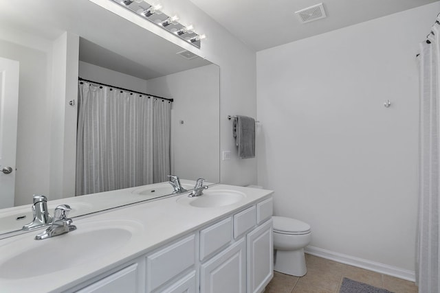 131 Bristol Ln Unit 2, Wood Dale, IL 60191 - full bath featuring double vanity, toilet, tile patterned flooring, baseboards, and a shower with curtain