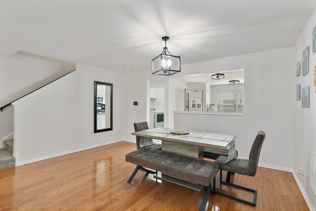 131 Bristol Ln Unit 2, Wood Dale, IL 60191 - dining room with stairway, baseboards, light wood finished floors, and a chandelier