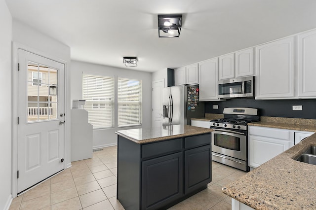 131 Bristol Ln Unit 2, Wood Dale, IL 60191 - kitchen featuring stainless steel appliances, white cabinetry, light tile patterned floors, and a kitchen island