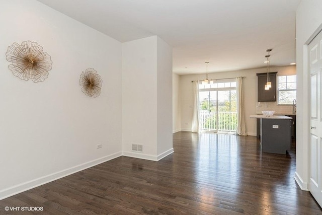 1425 N Charles Ave, Naperville, IL 60563 - unfurnished living room featuring dark wood-style flooring and baseboards