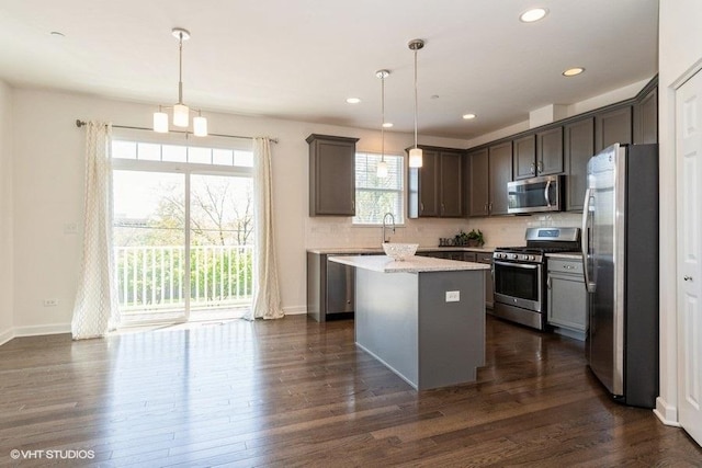 1425 N Charles Ave, Naperville, IL 60563 - kitchen with stainless steel appliances, decorative backsplash, a center island, dark wood-style floors, and recessed lighting