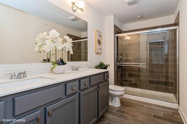 1425 N Charles Ave, Naperville, IL 60563 - bathroom featuring toilet, double vanity, a stall shower, and wood finished floors