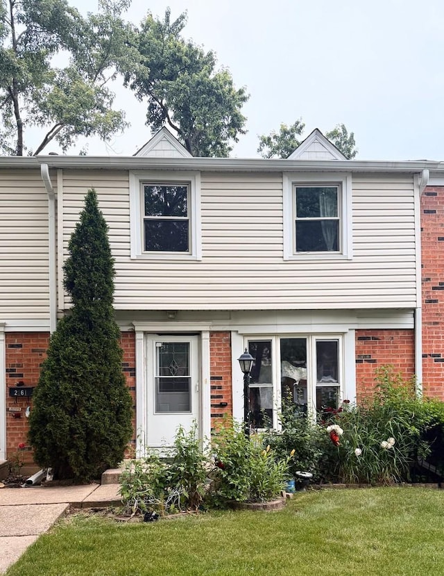 2062 Essex Ct, Streamwood, IL 60107 - colonial inspired home featuring brick siding and a front lawn