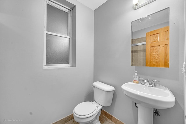4829 S Prairie Ave Unit 2, Chicago, IL 60615 - bathroom with toilet, baseboards, and tile patterned floors