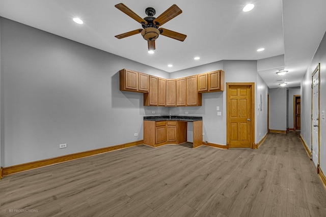 4829 S Prairie Ave Unit 2, Chicago, IL 60615 - kitchen featuring baseboards, dark countertops, a ceiling fan, light wood finished floors, and brown cabinets