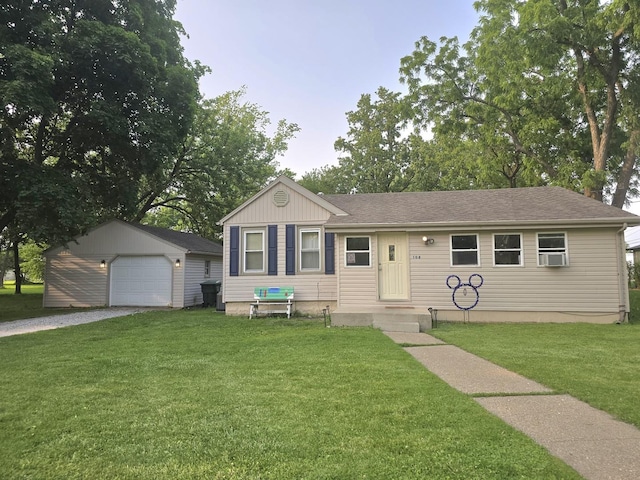 108 E Washington St, Ashkum, IL 60911 - view of front facade featuring gravel driveway, an outbuilding, a front lawn, a detached garage, and a shingled roof