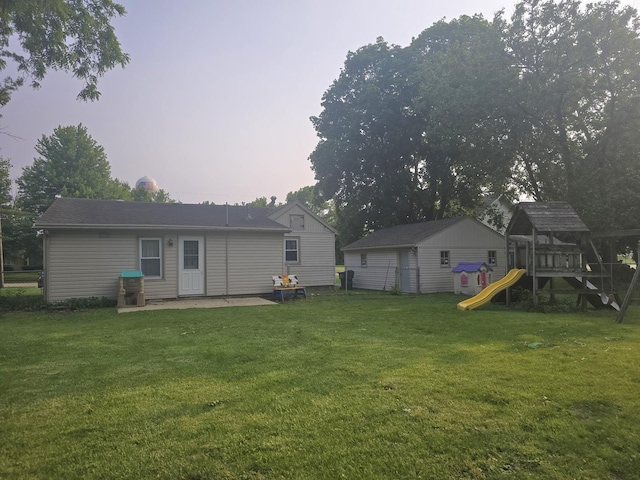108 E Washington St, Ashkum, IL 60911 - back of property featuring a playground and a lawn