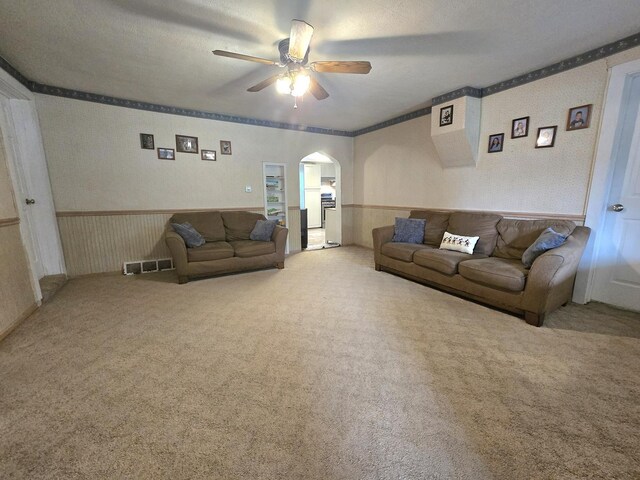 108 E Washington St, Ashkum, IL 60911 - carpeted living room featuring ceiling fan and arched walkways