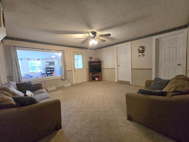 108 E Washington St, Ashkum, IL 60911 - carpeted living room with wainscoting, ceiling fan, and a textured ceiling