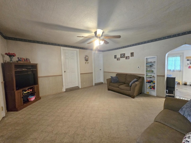 108 E Washington St, Ashkum, IL 60911 - living room with ceiling fan, wainscoting, carpet flooring, and arched walkways