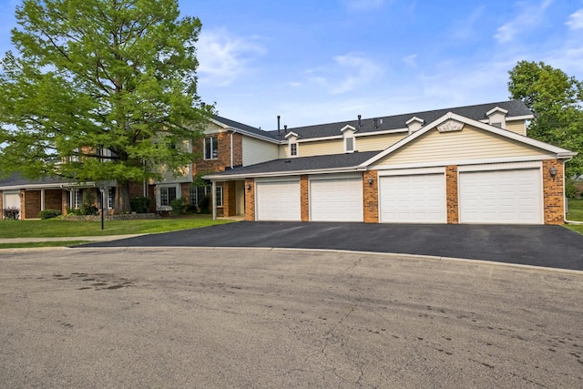 7215 Birchwood Ct Unit 19B, Willowbrook, IL 60527 - view of front of house featuring brick siding, a front yard, asphalt driveway, and a shingled roof
