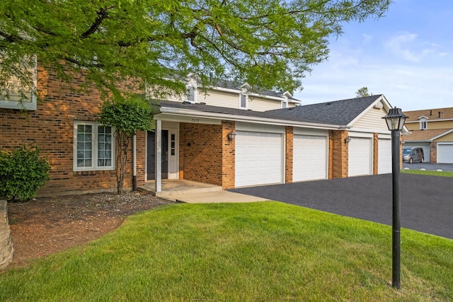 7215 Birchwood Ct Unit 19B, Willowbrook, IL 60527 - view of front of house with brick siding, a front yard, and asphalt driveway