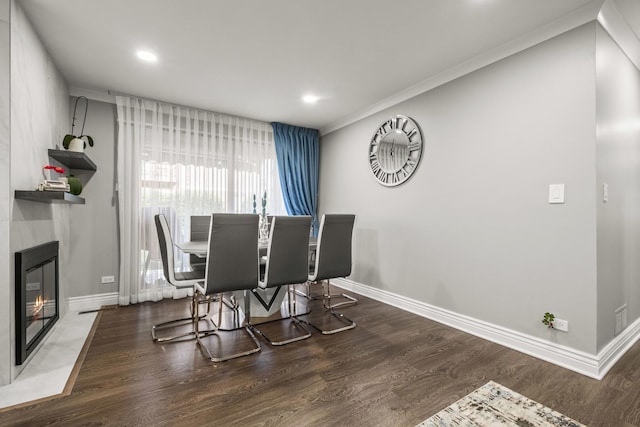 7215 Birchwood Ct Unit 19B, Willowbrook, IL 60527 - dining area featuring baseboards, wood finished floors, ornamental molding, recessed lighting, and a glass covered fireplace