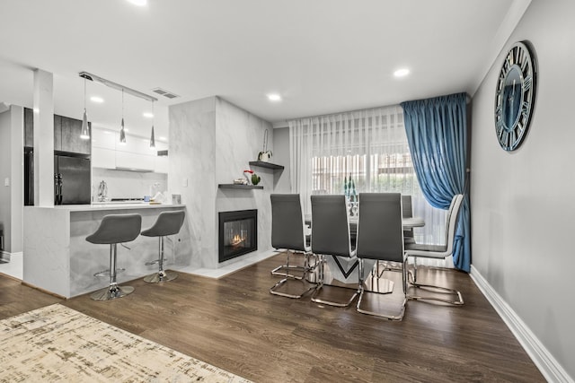 7215 Birchwood Ct Unit 19B, Willowbrook, IL 60527 - dining area featuring wood finished floors, recessed lighting, a glass covered fireplace, and baseboards