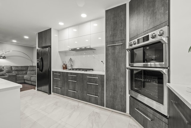 7215 Birchwood Ct Unit 19B, Willowbrook, IL 60527 - kitchen with black fridge with ice dispenser, double oven, modern cabinets, white cabinets, and under cabinet range hood