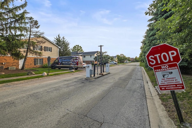 7215 Birchwood Ct Unit 19B, Willowbrook, IL 60527 - view of asphalt road with curbs and sidewalks