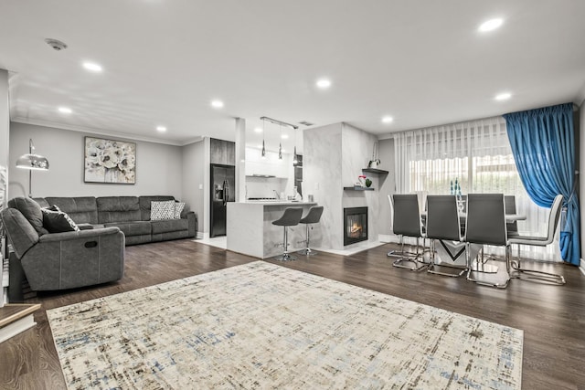 7215 Birchwood Ct Unit 19B, Willowbrook, IL 60527 - living room with dark wood-style flooring, recessed lighting, crown molding, baseboards, and a glass covered fireplace