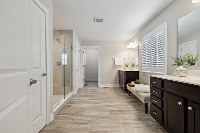 819 Heatherfield Cir, Naperville, IL 60565 - bathroom featuring a stall shower, two vanities, and baseboards