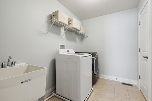 819 Heatherfield Cir, Naperville, IL 60565 - laundry room featuring washer and clothes dryer, baseboards, and light tile patterned flooring
